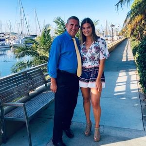 Francesca’s white romper with lots of colors and flowers